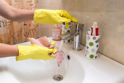 High angle view of man washing hands in sink