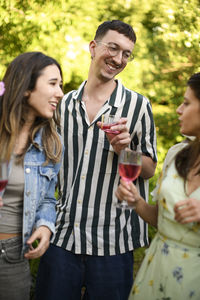 Smiling family standing outdoors