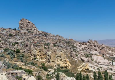 Scenic view of rocky mountains against clear blue sky