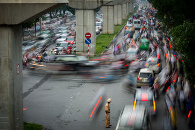 Blurred motion of people on street in city