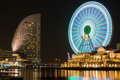 Low angle view of illuminated ferris wheel at night