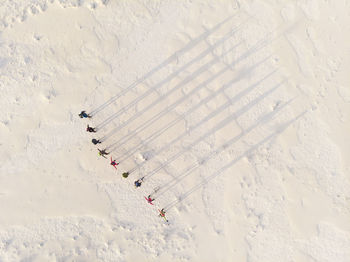 Aerial view of people standing on snow covered land