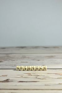 Close-up of text on wooden table