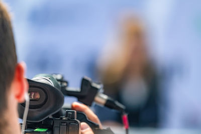 Close-up of man photographing with camera