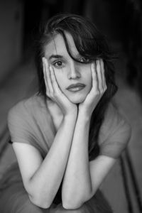 Portrait of young woman sitting at home