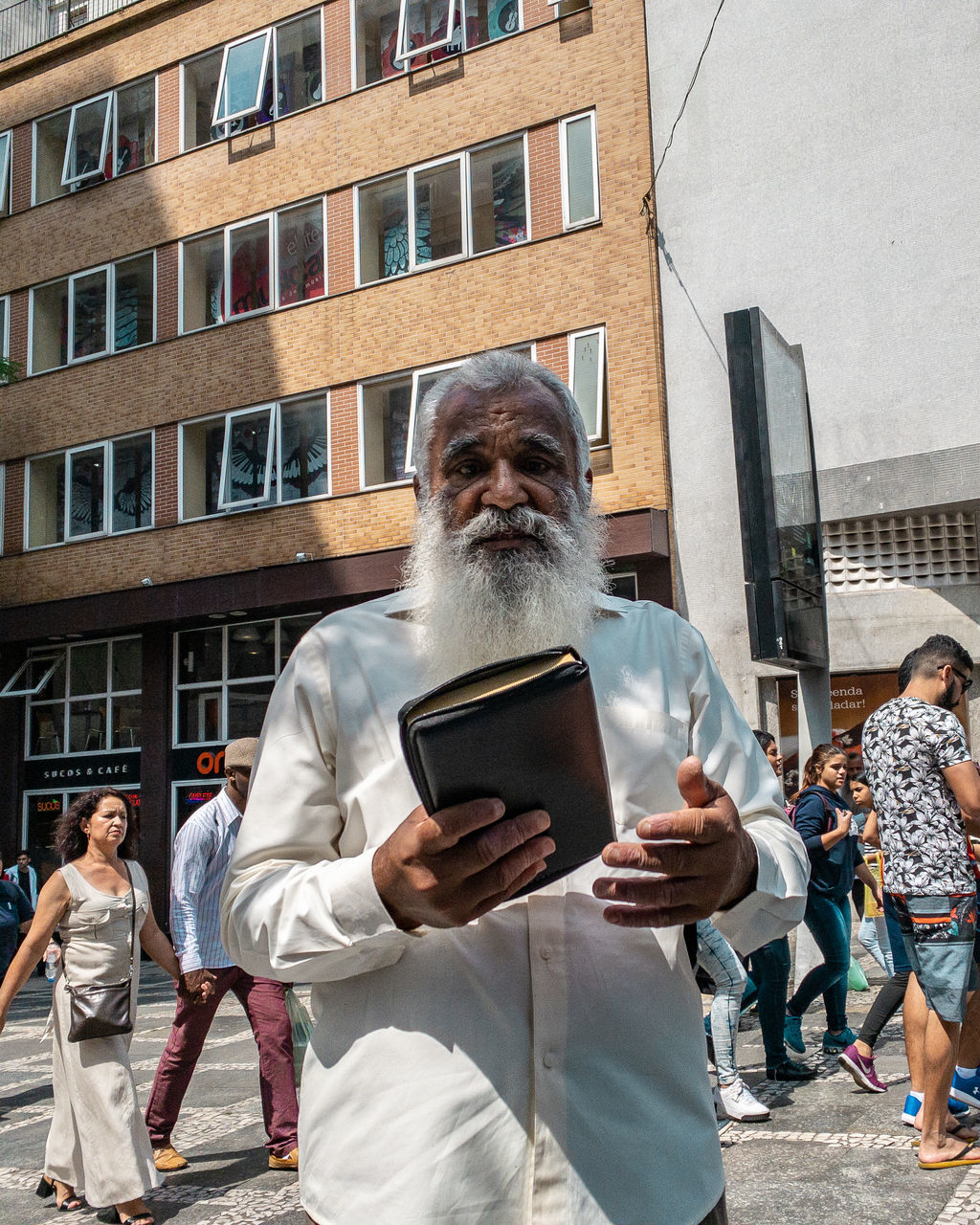 architecture, building exterior, built structure, men, real people, technology, building, city, communication, people, group of people, wireless technology, adult, front view, day, males, holding, women, lifestyles, reflection, outdoors