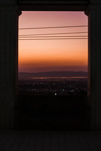 Silhouette buildings against sky during sunset