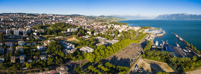 High angle view of townscape by sea against sky