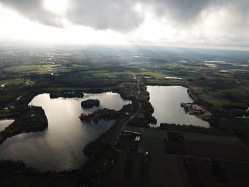 High angle view of river amidst cityscape against sky