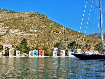 Boats in sea with mountains in background