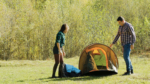 Rear view of man sitting on tent