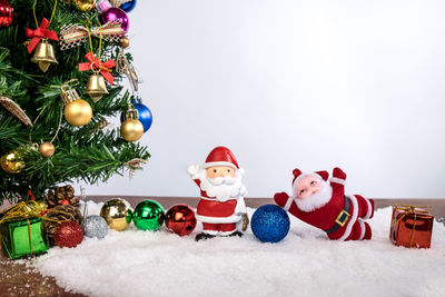 Close-up of christmas decorations against white background