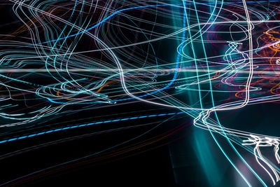 Close-up of light trails over black background