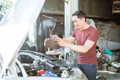 Side view of man using mobile phone