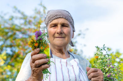 Close-up of man holding flower