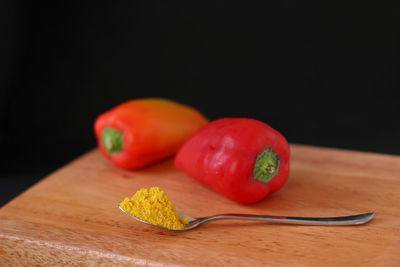 Close-up of tomatoes on table against black background