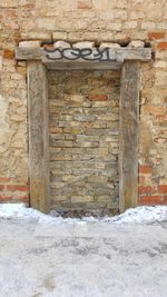 House against stone wall