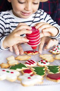 Smiling boy preparing gingerbread cookies at home