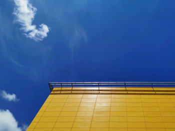 Low angle view of yellow building against sky