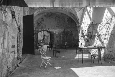 Empty chairs and tables in building