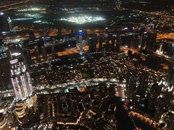 High angle view of illuminated city buildings at night