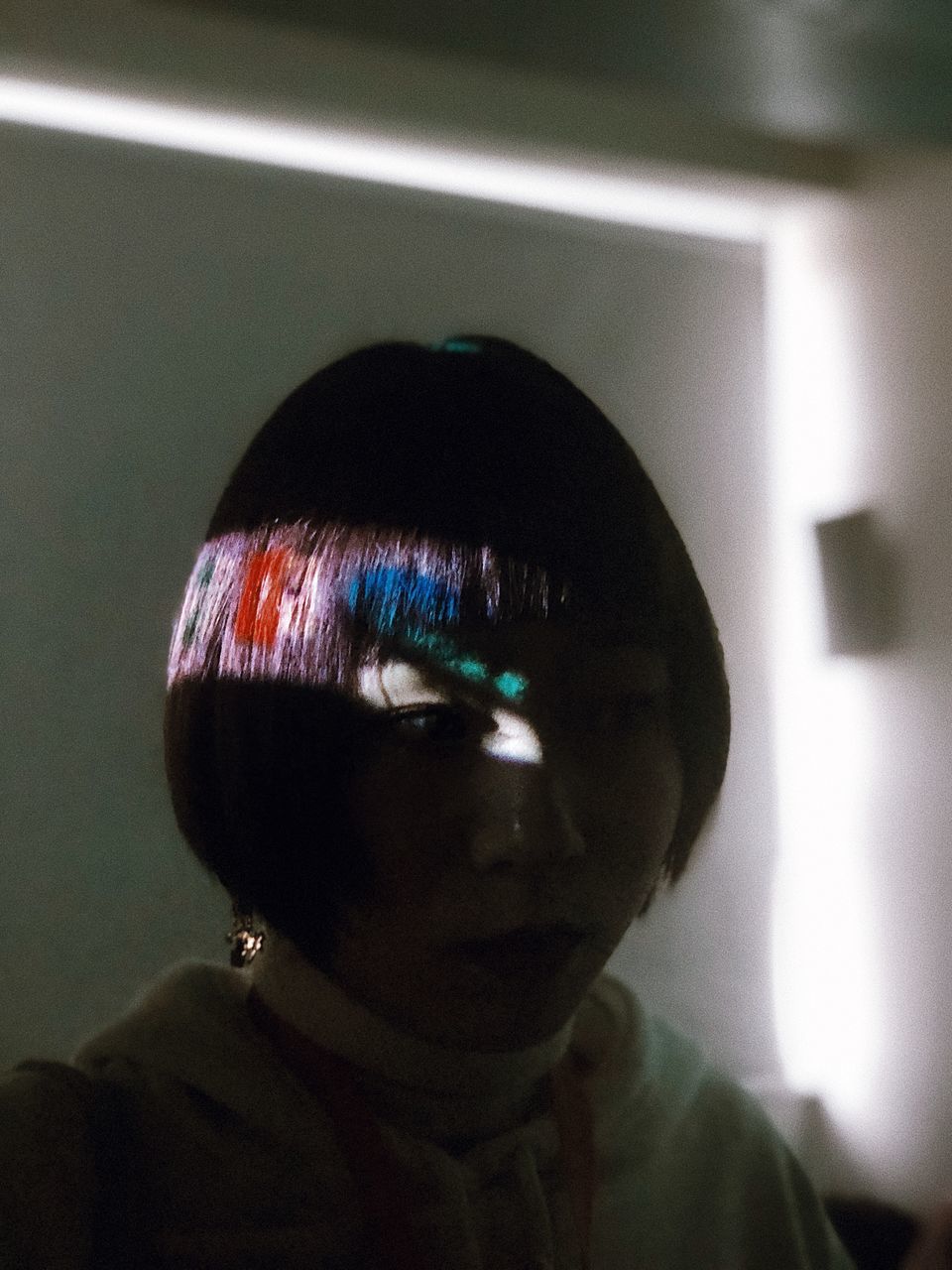 CLOSE-UP PORTRAIT OF BOY IN ILLUMINATED LIGHTING EQUIPMENT