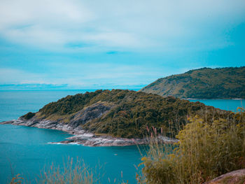 Scenic view of sea and mountains against sky