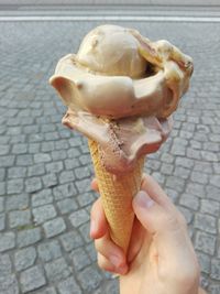 Close-up of hand holding ice cream cone