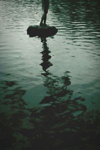 Low section of silhouette man on rippled lake