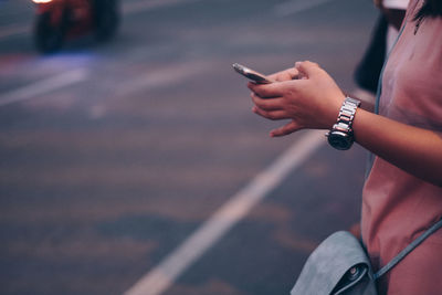 Midsection of woman using mobile phone