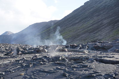 Scenic view of waterfall against sky