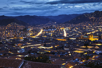 High angle view of illuminated city against sky at night