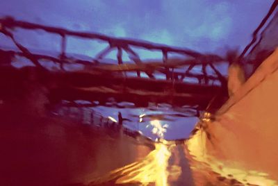 Illuminated bridge against sky at night