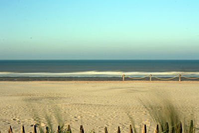 Scenic view of beach against clear sky