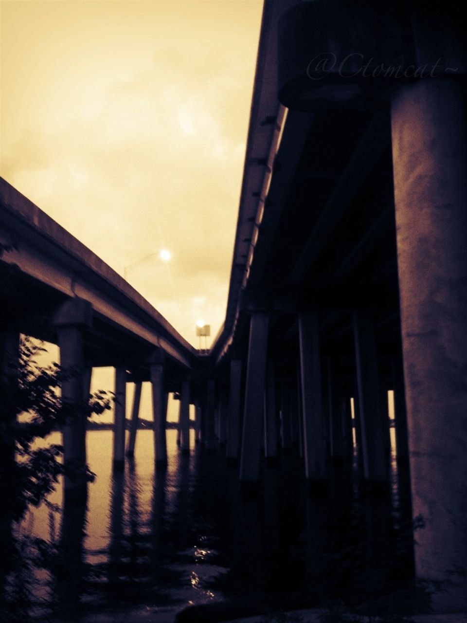 built structure, architecture, sunset, architectural column, sky, bridge - man made structure, water, column, building exterior, reflection, low angle view, connection, cloud - sky, bridge, waterfront, pier, sea, support, sunlight, outdoors