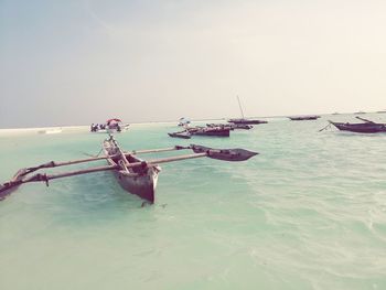 Nautical vessel moored on sea against clear sky