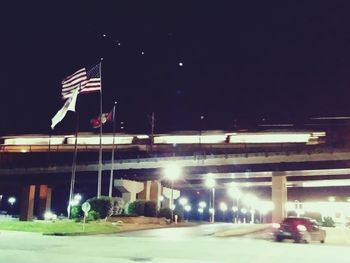 Illuminated flag in city at night