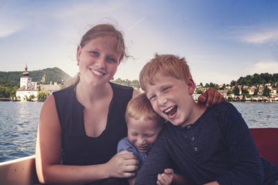 Portrait of happy siblings in boat 