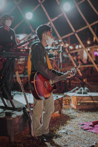 Man playing guitar at music concert