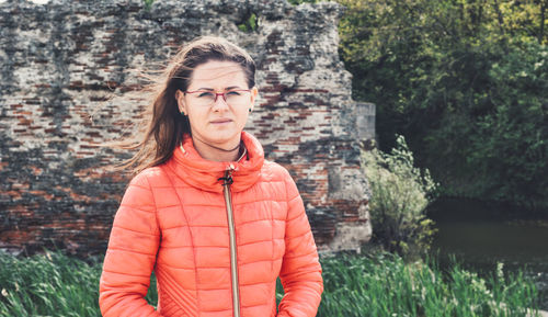 Portrait of woman standing against trees