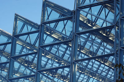 Low angle view of communications tower against sky