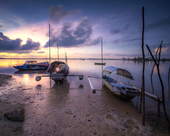 Boats moored at harbor