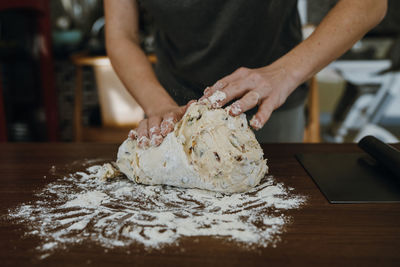 Midsection of man preparing food on table