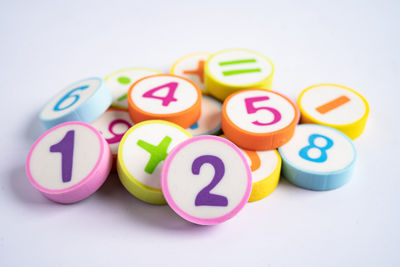 Close-up of multi colored toys over white background