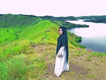 Portrait of woman in headscarf standing on mountain