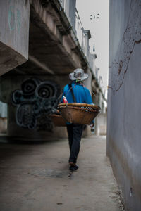 Rear view of man walking in building