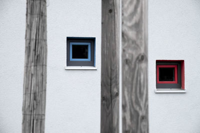 Red and blue window frames on white wall