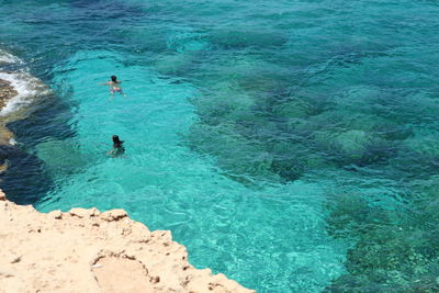 High angle view of people swimming in sea