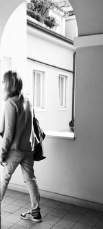 Full length of woman standing by railing