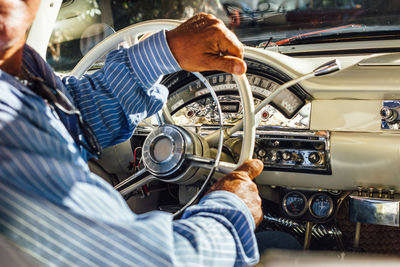 Midsection of man driving vintage car